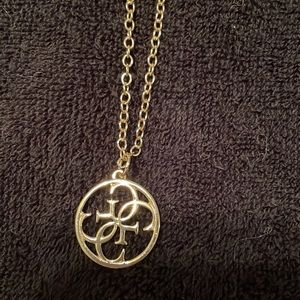 Guess gold tone necklace with a medallion with 4 G’s for Guess.